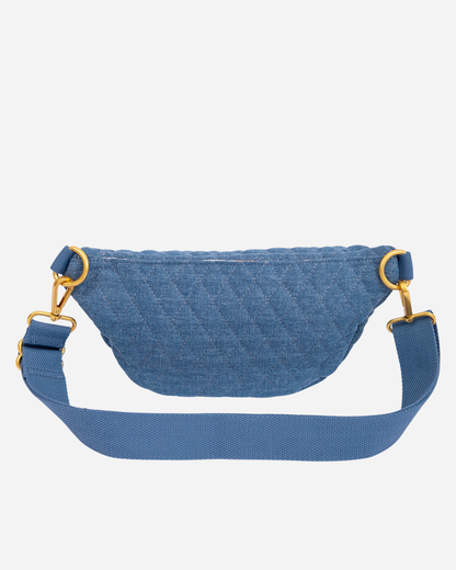 Blue denim Fawny Pack with gold hardware on a white background