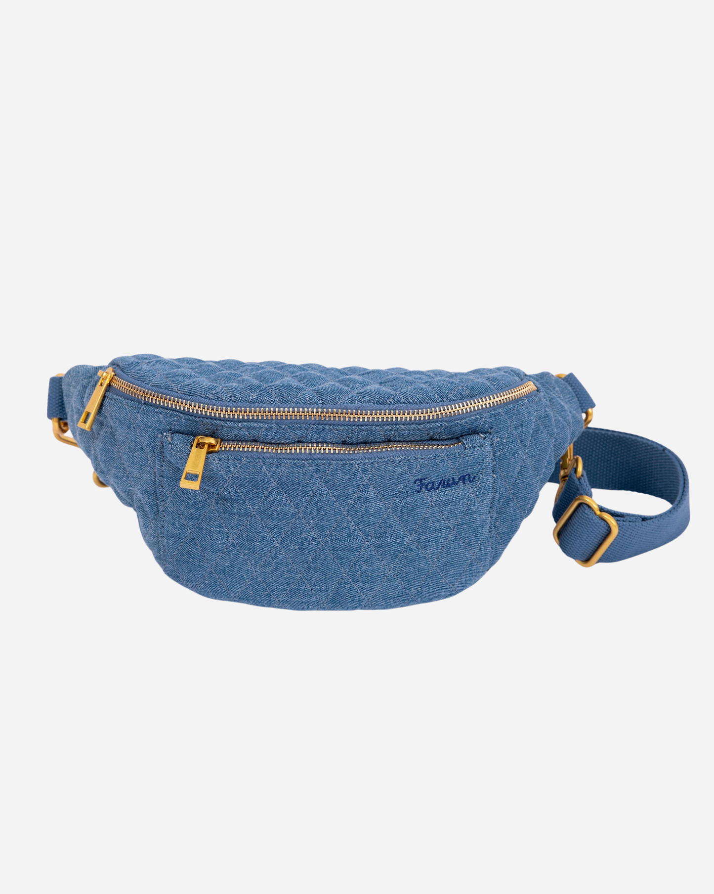 Blue denim Fawny Pack with gold zippers on a light gray background