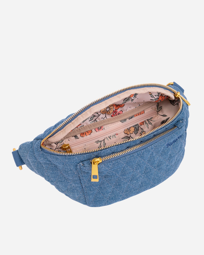 Blue denim Fawny Pack with floral interior on a white background